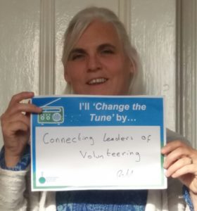 Ruth Leonard, Chair of AVM, holds up an IVM Day pledge which says "I