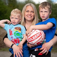 Imo Greatbatch, holding her two boys and a football.