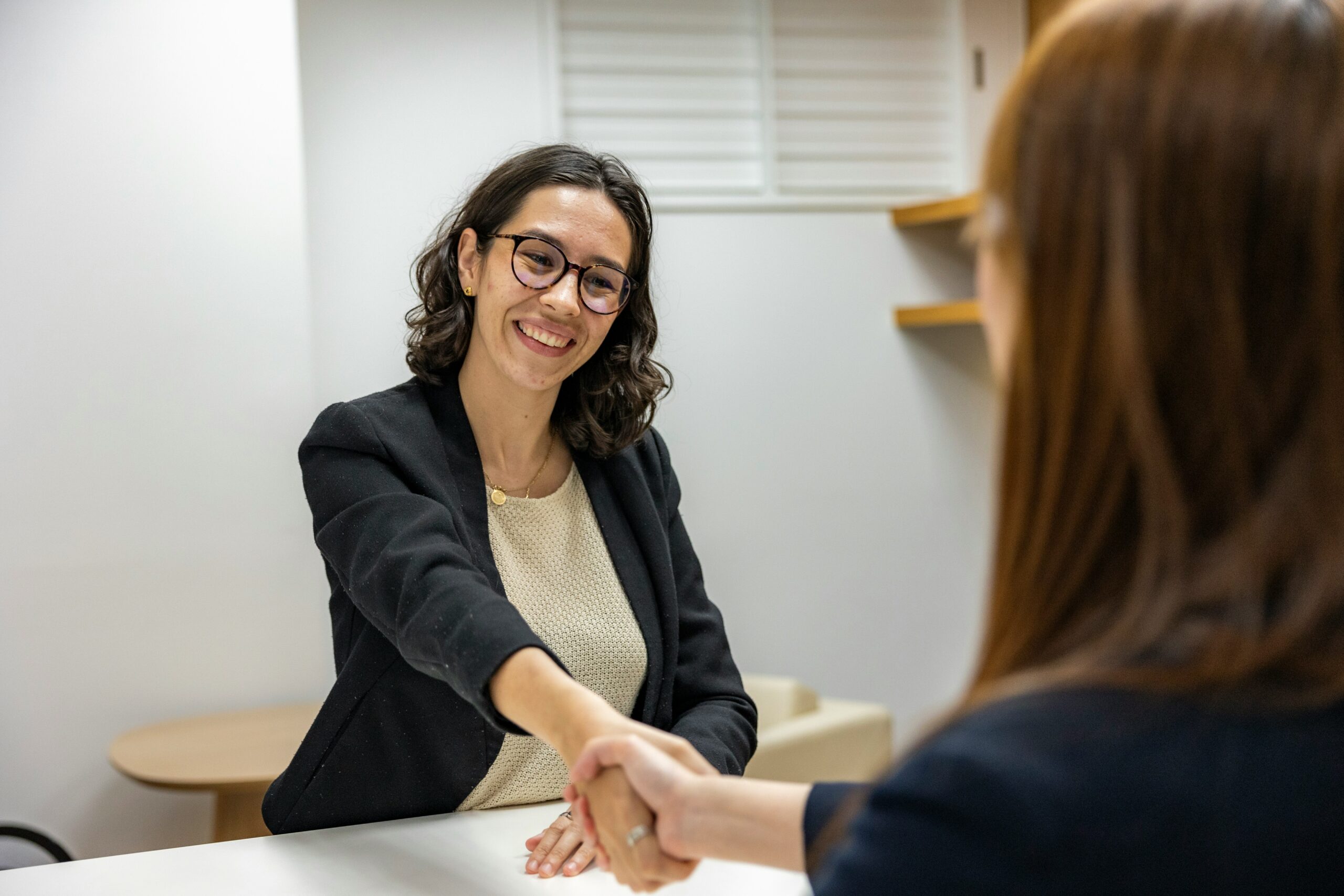 Woman shaking hands at job interview