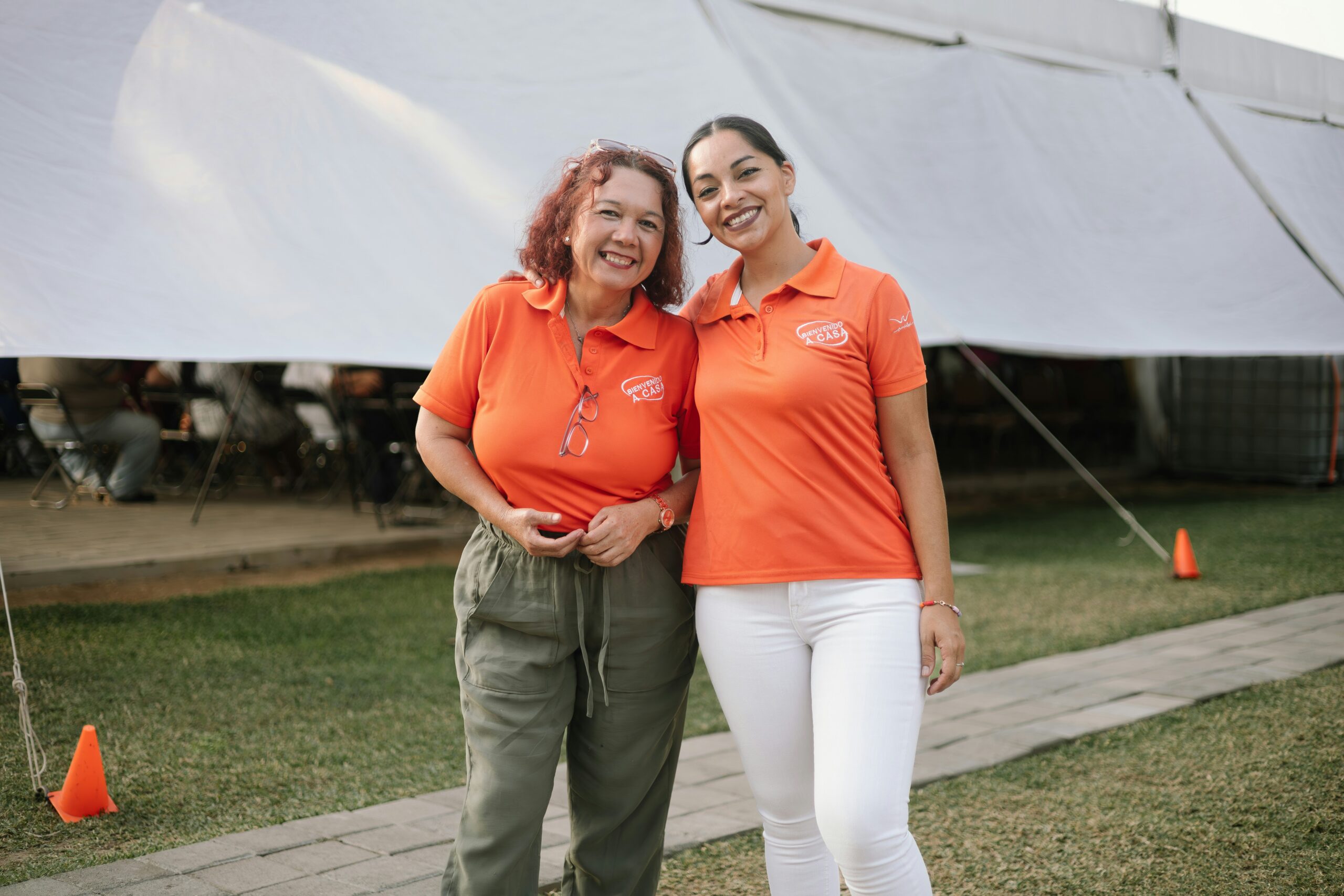 Two volunteers standing next to each other and smiling